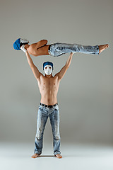 Image showing The two gymnastic acrobatic caucasian men on balance pose