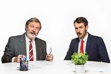 Image showing The two colleagues working together at office on white background.