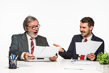 Image showing The two colleagues working together at office on white background.