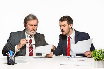 Image showing The two colleagues working together at office on white background.