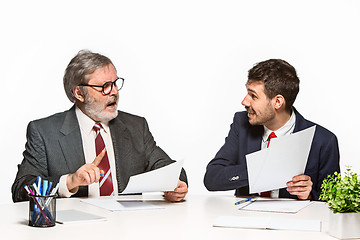 Image showing The two colleagues working together at office on white background.