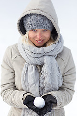 Image showing Girl holding snowball in cold winter time.