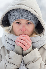 Image showing Portrait of lady outdoor in snow in cold winter time.