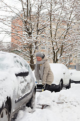 Image showing Independent woman shoveling snow in winter.