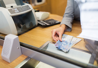 Image showing clerk with swiss francs cash money at bank office