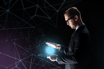 Image showing businessman with light above transparent tablet pc