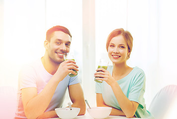 Image showing smiling couple having breakfast at home