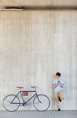 Image showing man with smartphone and fixed gear bike on street