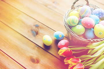 Image showing close up of easter eggs in basket and flowers