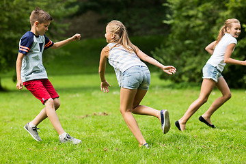 Image showing group of happy kids or friends playing outdoors