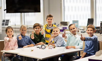 Image showing happy children building robots at robotics school