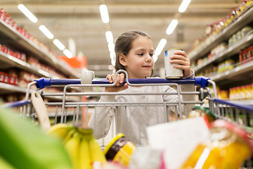 Image showing girl with food in shopping cart at grocery store