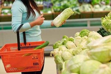 Image showing woman with basket and chinese cabbage at grocery