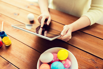 Image showing close up of woman with tablet pc and easter eggs