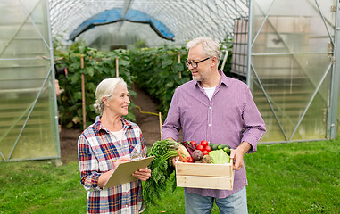 Image showing senior couple with box of vegetables on farm