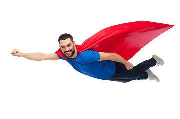 Image showing happy man in red superhero cape flying on air