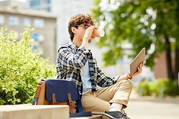 Image showing man with tablet pc and coffee on city street bench