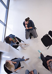 Image showing Multiethnic startup business team on meeting  top view