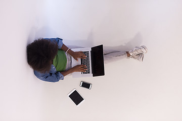 Image showing african american woman sitting on floor with laptop top view