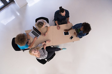 Image showing Multiethnic startup business team on meeting  top view