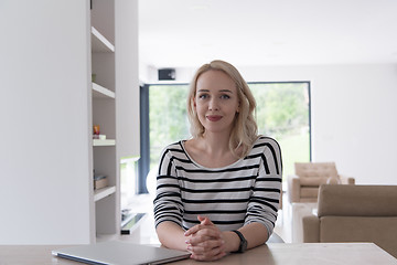 Image showing Young woman with laptop at home