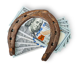 Image showing Old rusty horseshoe and money