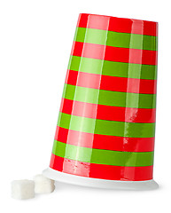 Image showing Inverted red and green cup with sugar cubes