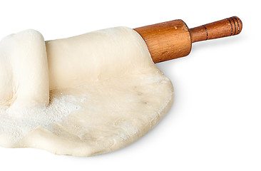 Image showing Closeup rolling pin covered with dough