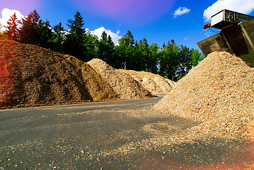 Image showing storage of wooden fuel (biomass) against blue sky