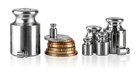 Image showing Several old scaling weights and coins