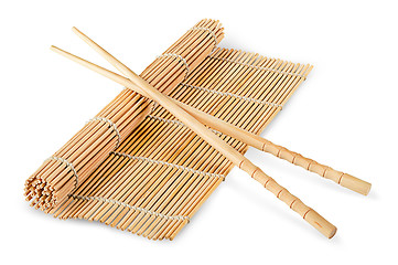 Image showing Sushi mat partially deployed and chopsticks