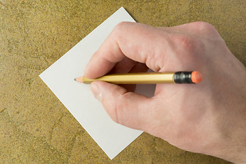 Image showing Hand with pencil and piece of sheet