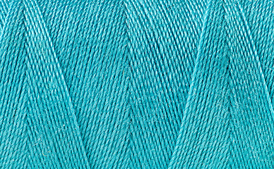 Image showing Blue thread spooled on a bobbin