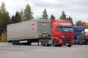 Image showing Red Truck Backs Up Cargo Trailer