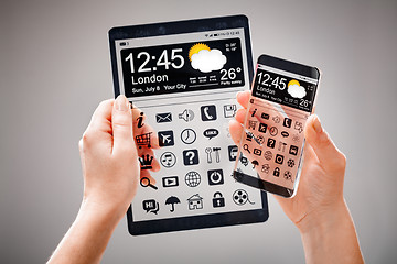 Image showing Smartphone and tablet with transparent screen in human hands.