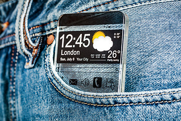 Image showing Smartphone with a transparent screen in a pocket of jeans.