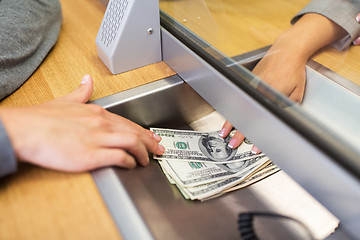 Image showing clerk giving cash money to customer at bank office