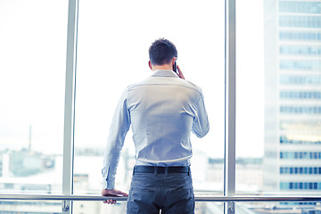 Image showing businessman calling on smartphone in office