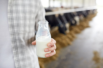 Image showing close up of man or farmer with milk on dairy farm