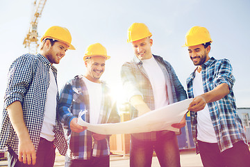 Image showing group of builders with tablet pc and blueprint