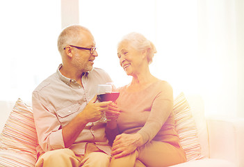 Image showing happy senior couple with glasses of red wine