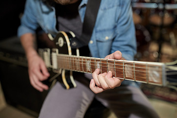 Image showing man playing guitar at studio rehearsal