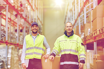 Image showing men in uniform with boxes at warehouse