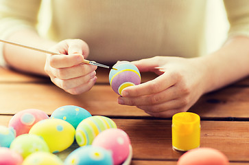 Image showing close up of woman hands coloring easter eggs