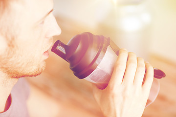 Image showing close up of man drinking protein shake