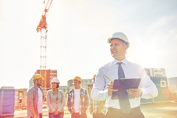 Image showing happy builders and architect at construction site