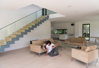 Image showing couple relaxing at  home with tablet computers