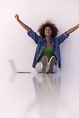 Image showing african american woman sitting on floor with laptop