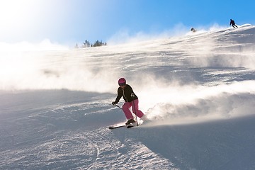 Image showing Female skier in fresh powder snow and sunlight