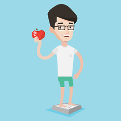 Image showing Man standing on scale and holding apple in hand.